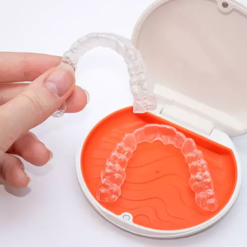 Transparent aligners retainers in a storage case. Invisible brac Transparent aligners retainers in a storage case. Invisible brac